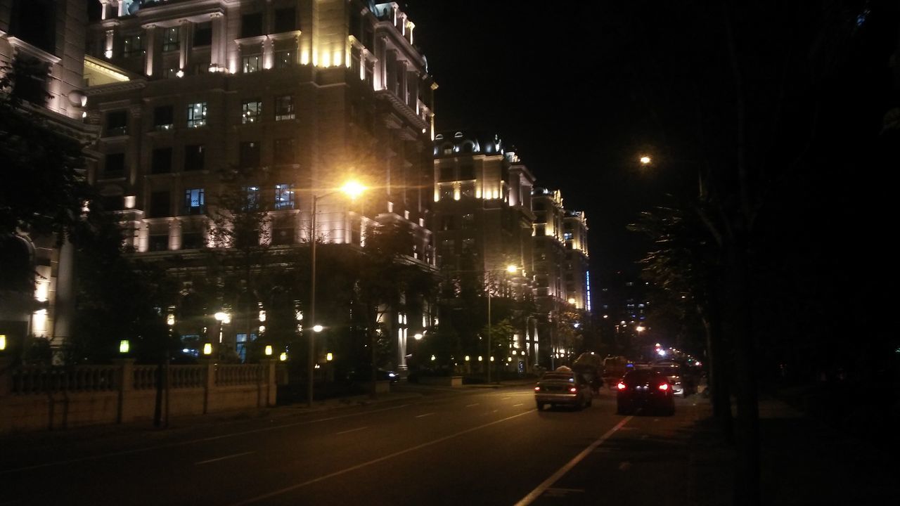 VIEW OF CITY STREET AT NIGHT