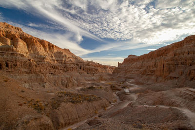 Scenic view of desert canyon against sky