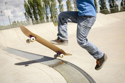 Low section of boy skateboarding on ramp