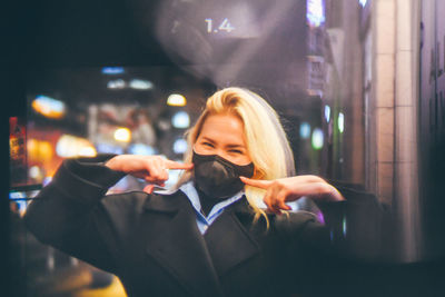 Portrait of young woman using mobile phone at night