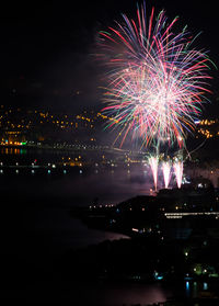 Firework display in city at night