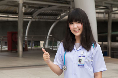 Young female doctor standing in city