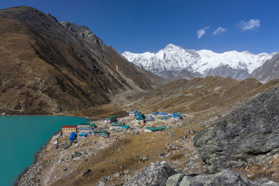 Scenic view of snowcapped mountains against blue sky