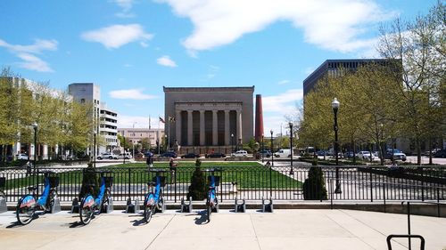 People on street against buildings in city
