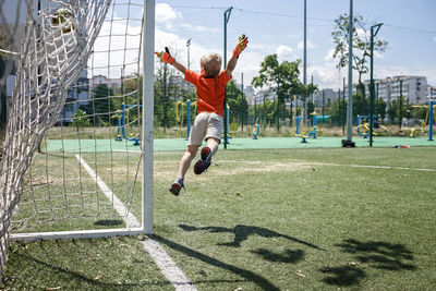 Full length of boy playing soccer