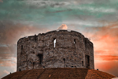 Old building against cloudy sky