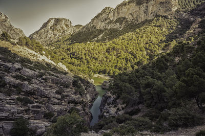 Scenic view of land and mountains against sky