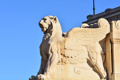 Low angle view of statue against blue sky