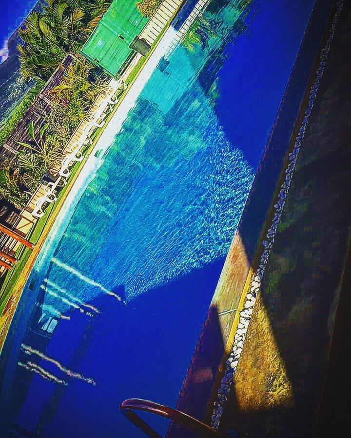 HIGH ANGLE VIEW OF SWIMMING POOL IN SEA
