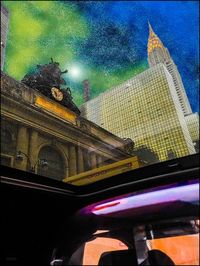 Low angle view of illuminated building against sky at night