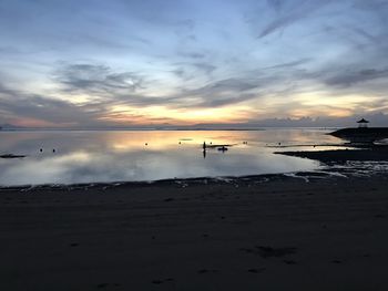 Scenic view of beach against sky during sunset