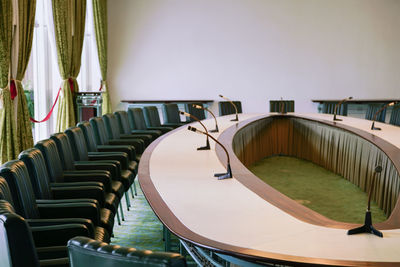 Empty chairs and table in conference room