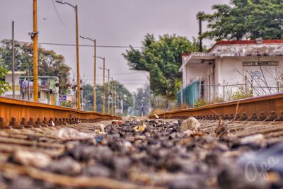 Railroad tracks by train against sky