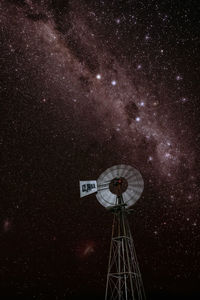 Low angle view of clock tower against sky at night