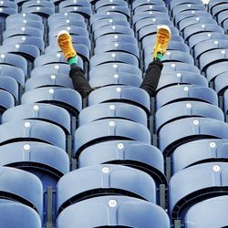 Low section of man on bleacher at stadium