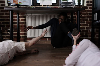 Full length of woman sitting on floor