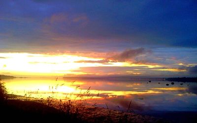 Scenic view of lake at sunset