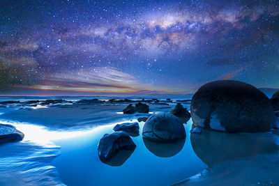 Scenic view of sea against sky at night