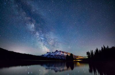 Scenic view of lake against star field at night