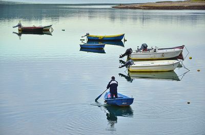 Men fishing in boat on sea