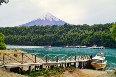 Built structure in water with mountain in background