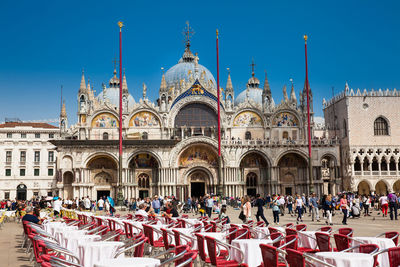 Restaurants and tourists at the famous saint mark square of venice in a beautiful early spring day