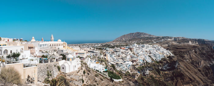 Panoramic view of townscape against clear blue sky