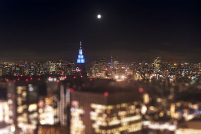 Night-time panoramic view from the tokyo metropolitan government building on a full moon night.