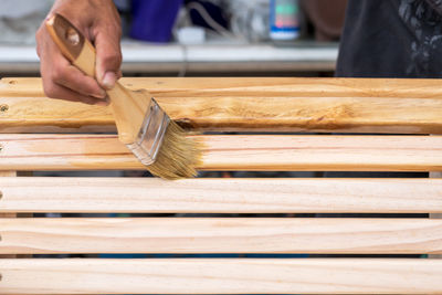 Close-up of man working on wooden table