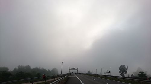 Car on highway against storm clouds