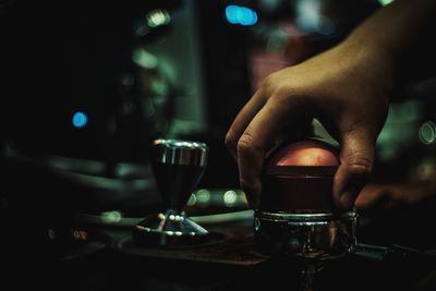 Midsection of man holding wine glass