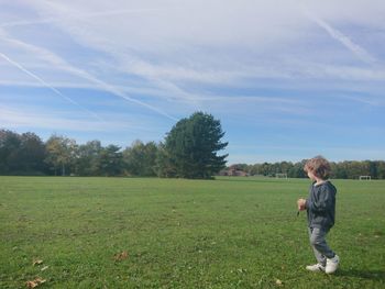 Full length of boy standing on playing field