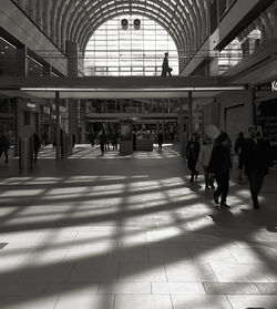 Group of people walking on tiled floor in city