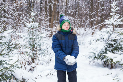 Portrait of teenage girl standing in snow