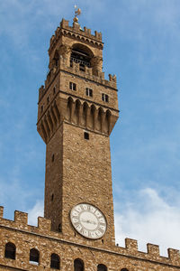 Clock tower of the palazzo vecchio built at the piazza della signoria in florence