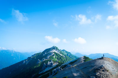 Scenic view of snowcapped mountains against cloudy sky