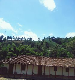 Houses against cloudy sky