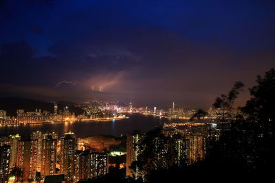 High angle view of illuminated city buildings at night