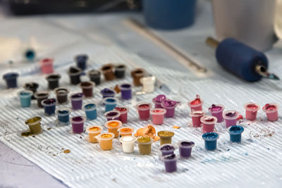 Close-up of multi colored tattoo ink pots