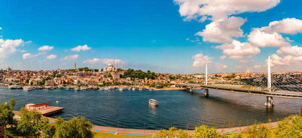 Scenic view of river by buildings against sky