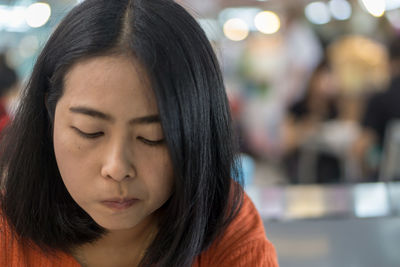 Close-up portrait of a beautiful young woman with eyes closed