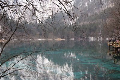 Beatiful landscape of a lake between mountains with reflexion of trees in the water in jiuzhaigou 