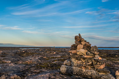 Stack of rocks on beach against sky