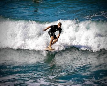 Full length of man splashing water in sea