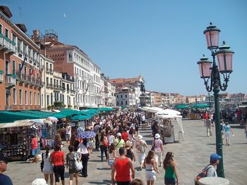 High angle view of people on street in city on sunny day