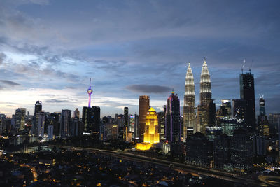 View of skyscrapers against cloudy sky