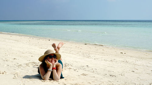 Woman sunbathing at beach