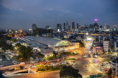 High angle view of illuminated buildings in city against sky at night