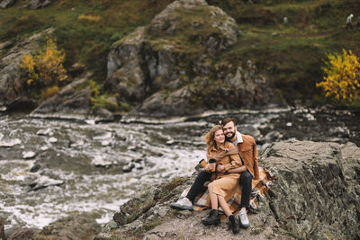 Happy people in love are travel hike in nature in the autumn forest. romantic trip to countryside