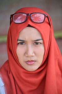 Close-up portrait of woman wearing red hijab